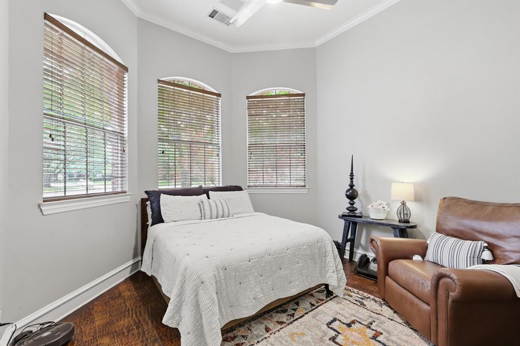 462 Copperstone Trail Coppell, TX 75019 - Photo 24 of 38 a bedroom with a bed and wooden floor