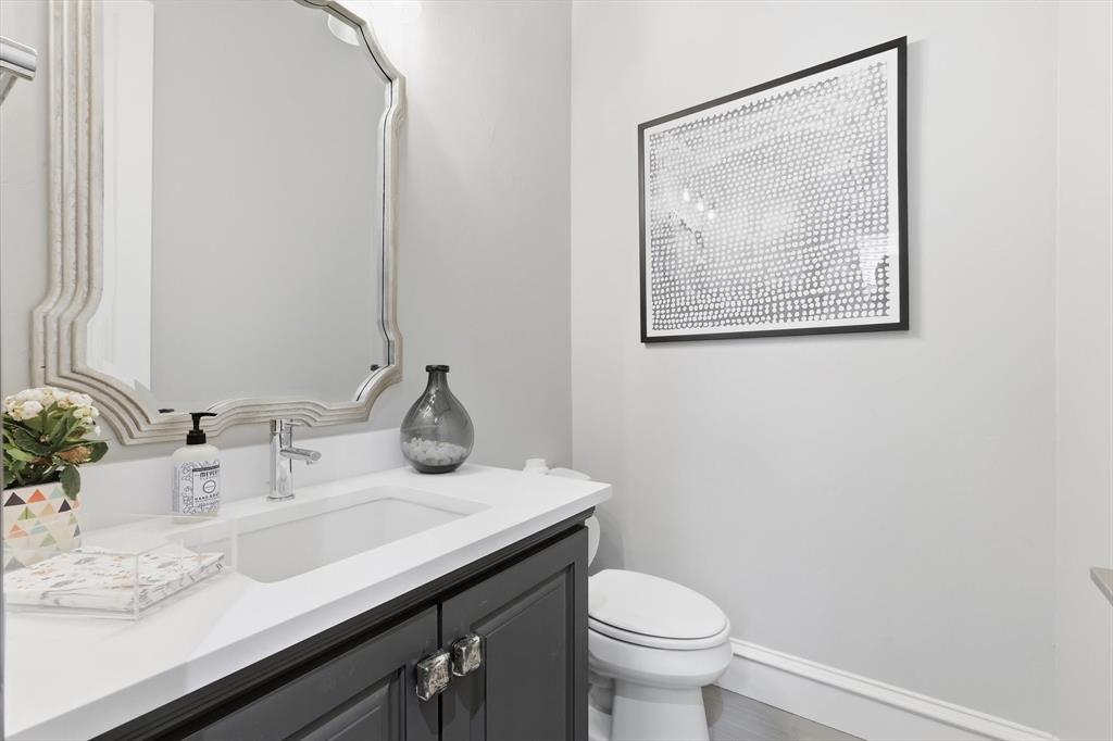 462 Copperstone Trail Coppell, TX 75019 - Photo 25 of 38 a bathroom with a granite countertop sink and a toilet