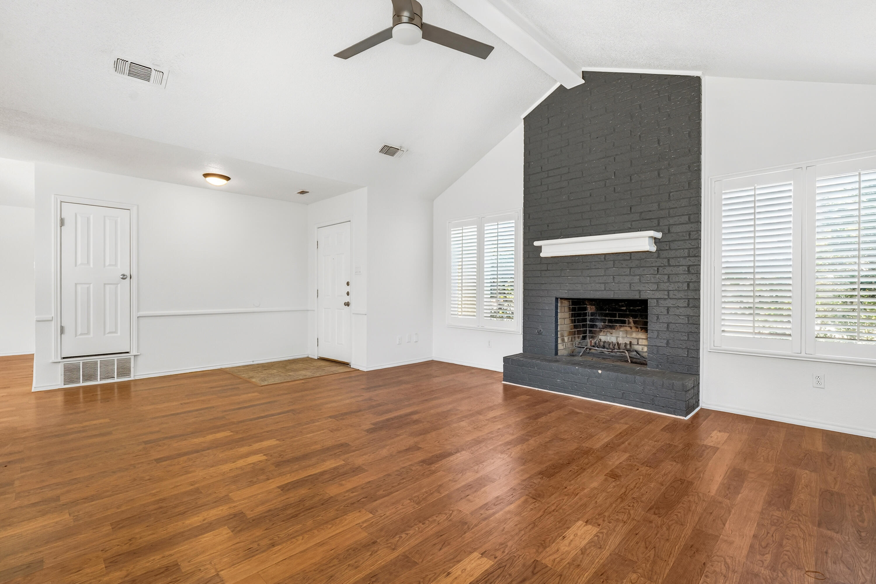 5221 84th Street Lubbock, TX 79424 - Photo 5 of 26 a view of empty room with wooden floor and fireplace