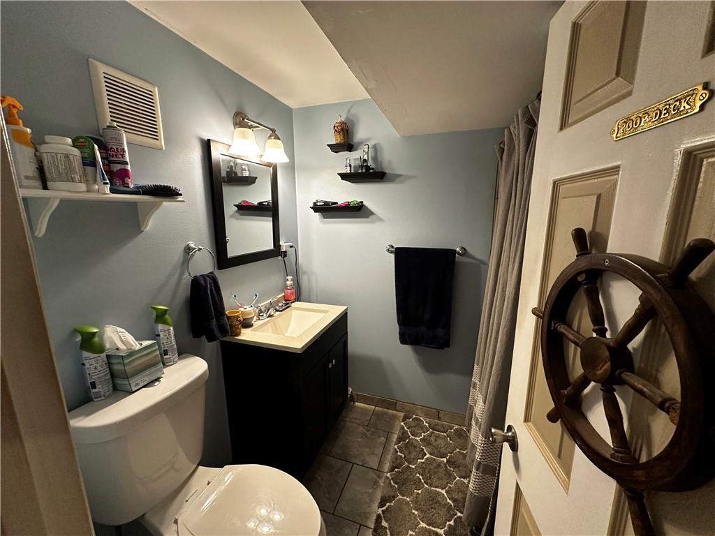 408 Craigdell Road New Kensington, PA 15068 - Photo 9 of 12 a bathroom with a sink toilet and mirror