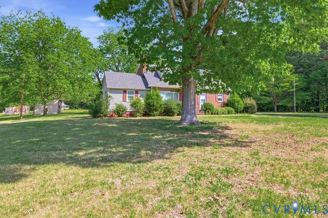 8100 Sandy Ridge Road Hopewell, VA 23860 - Photo 4 of 36 Expansive green lawn with mature shade trees surro