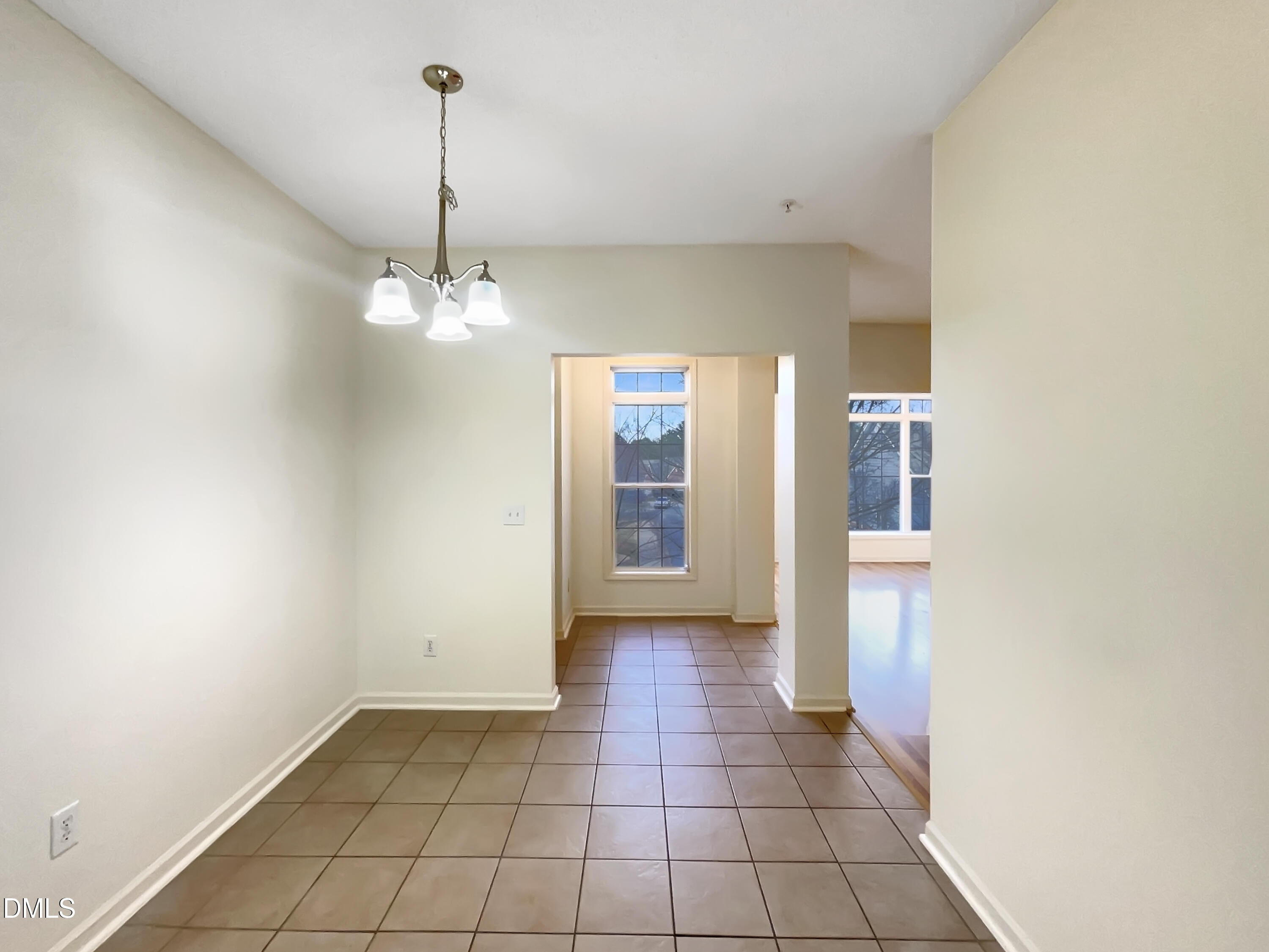 2501 Huntscroft Lane, Unit 203 Raleigh, NC 27617 - Photo 6 of 16 a view of a hallway with a chandelier