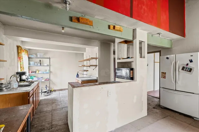 a kitchen with stainless steel appliances a refrigerator and a stove