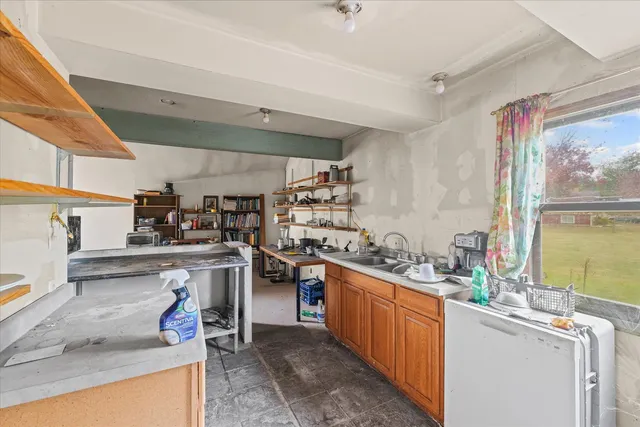a kitchen with a sink stove and cabinets