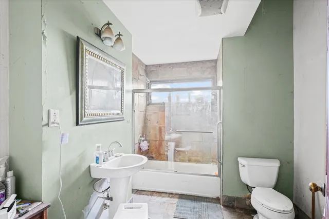 a bathroom with a toilet a sink and a mirror