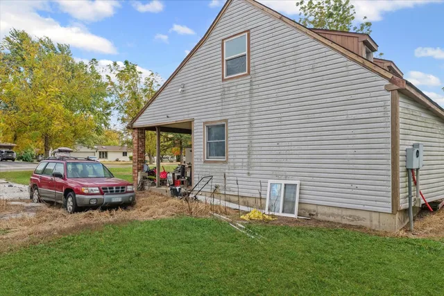 a view of a house with a backyard and a patio