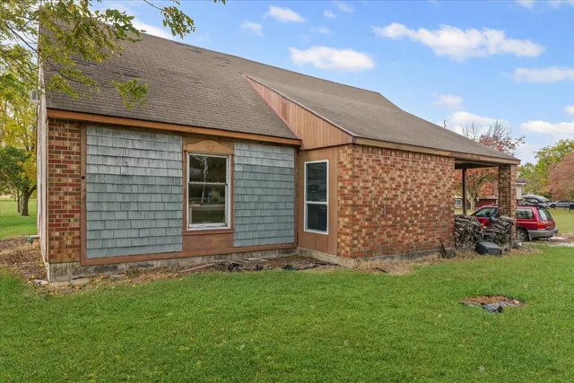 a front view of a house with a garden