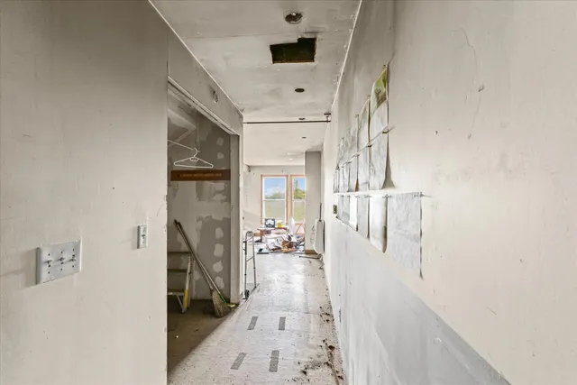 a hallway with a white stove next to a window