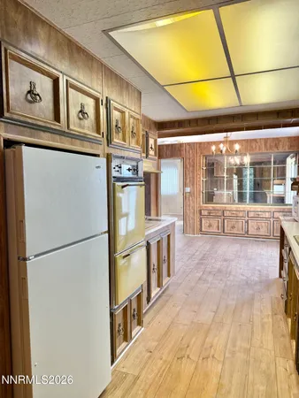 a view of a kitchen with a refrigerator and a stove