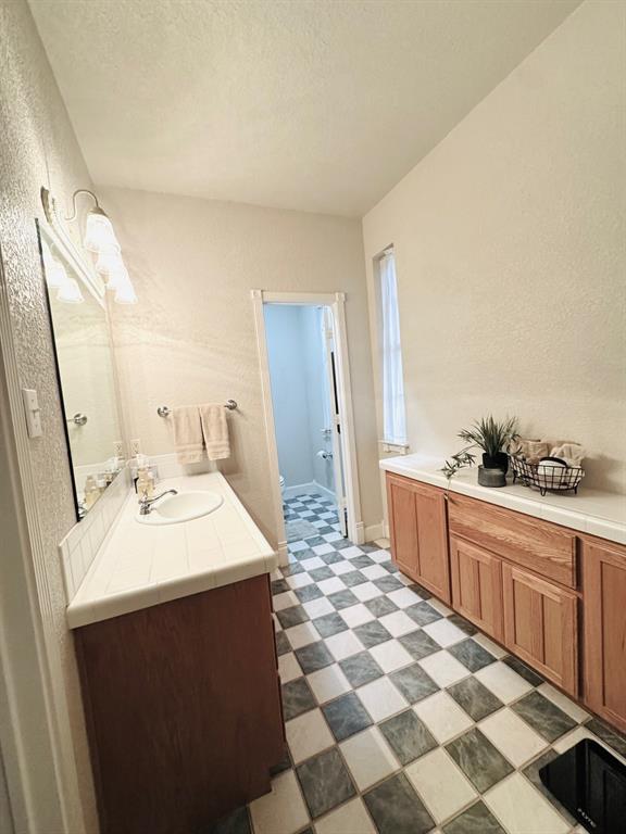 400 Indian Hills Road Gatesville, TX 76528 - Photo 24 of 38 a large white kitchen with a sink a stove a mirror and cabinets