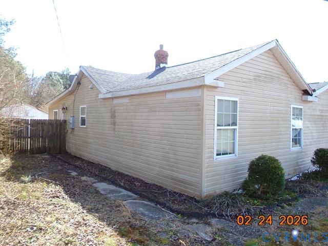 3034 Bradley Farm Road Tappahannock, VA 22560 - Photo 7 of 14 View of home's exterior featuring a chimney and ro