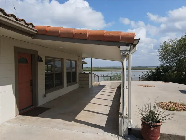 a view of a balcony with floor to ceiling windows yard