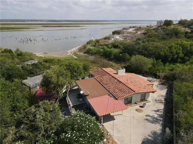 an aerial view of a house with a lake view