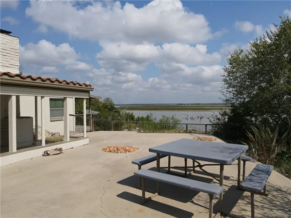 a view of balcony with wooden floor and fence