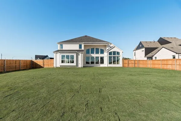 an aerial view of a house with garden space and lake view
