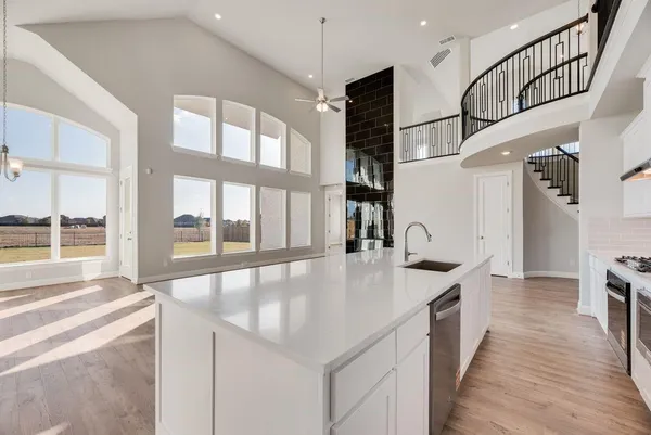a open kitchen with stainless steel appliances granite countertop a sink and a stove