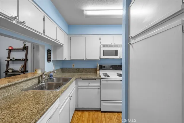 a kitchen with granite countertop a sink and cabinets