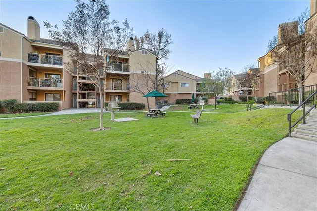 a view of city street with a building and trees in the background