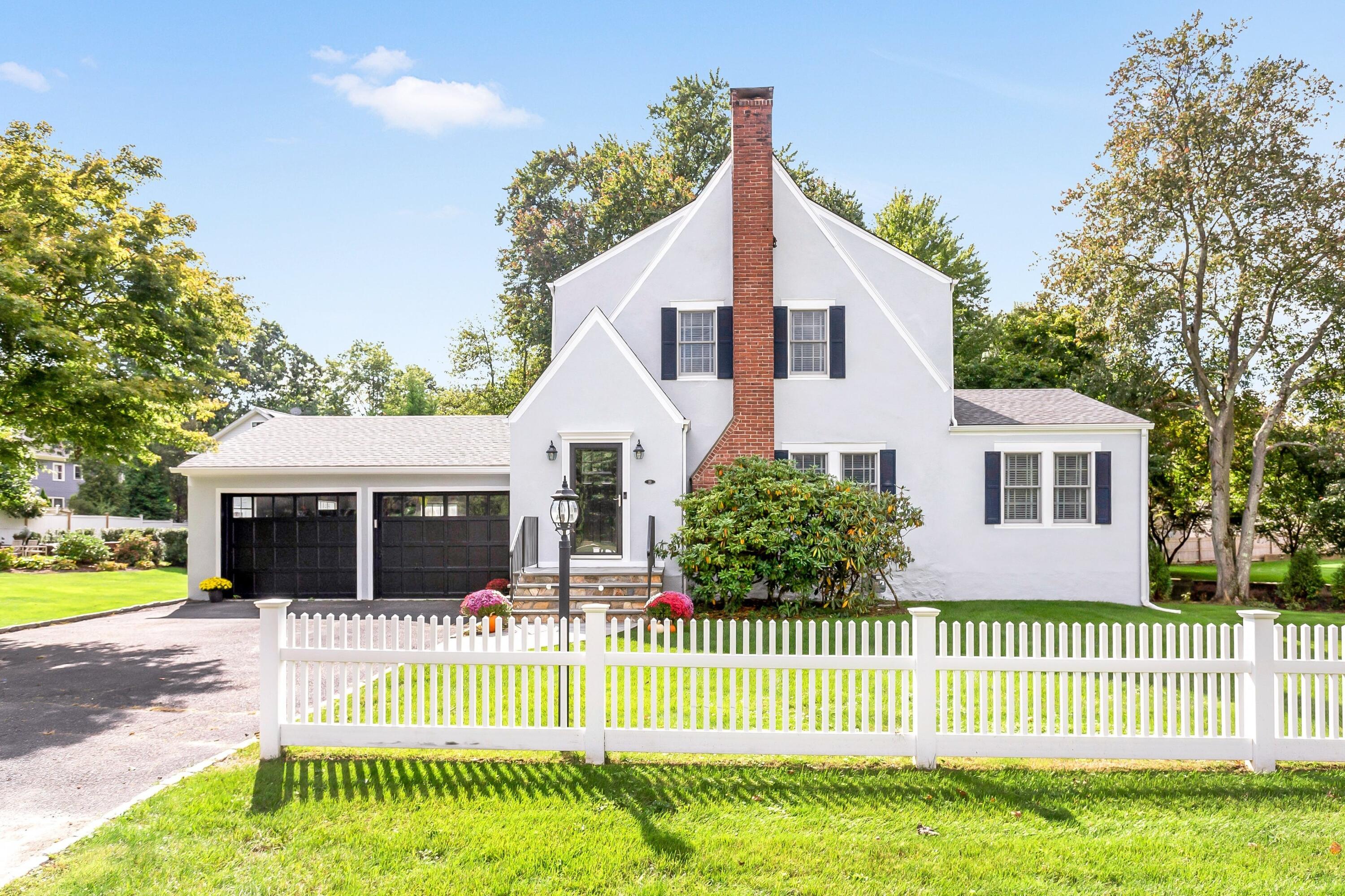 23 Renshaw Road Darien, CT 06820 - Photo 1 of 34 a front view of a house with a garden and plants
