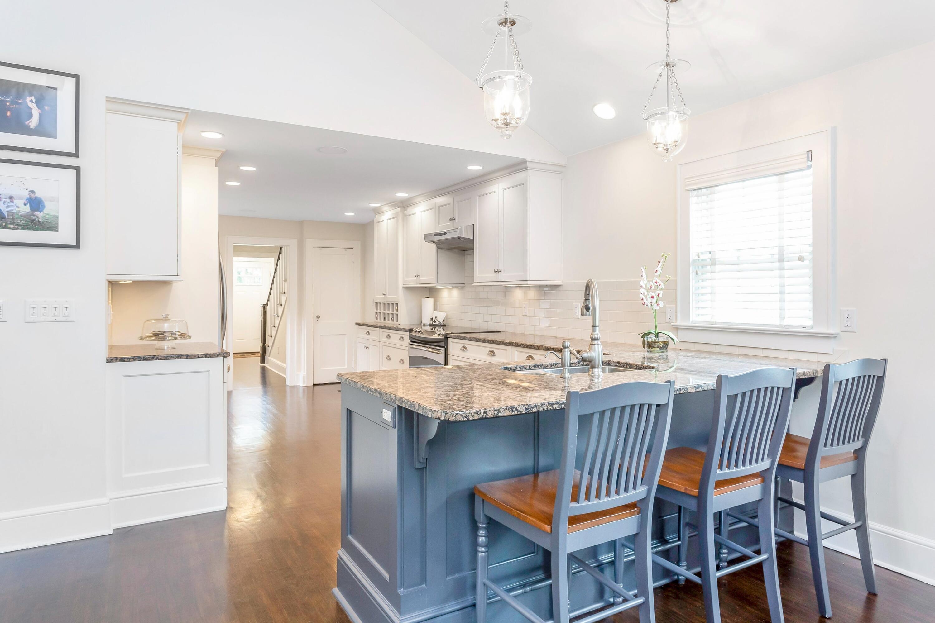 23 Renshaw Road Darien, CT 06820 - Photo 14 of 34 a kitchen with a dining table chairs sink and cabinets