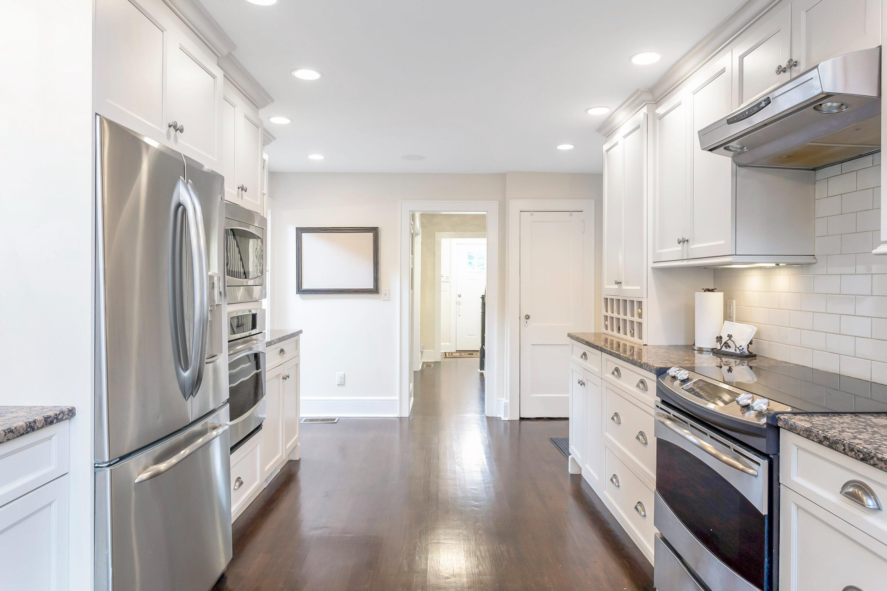 23 Renshaw Road Darien, CT 06820 - Photo 15 of 34 a kitchen with stainless steel appliances and wooden floor