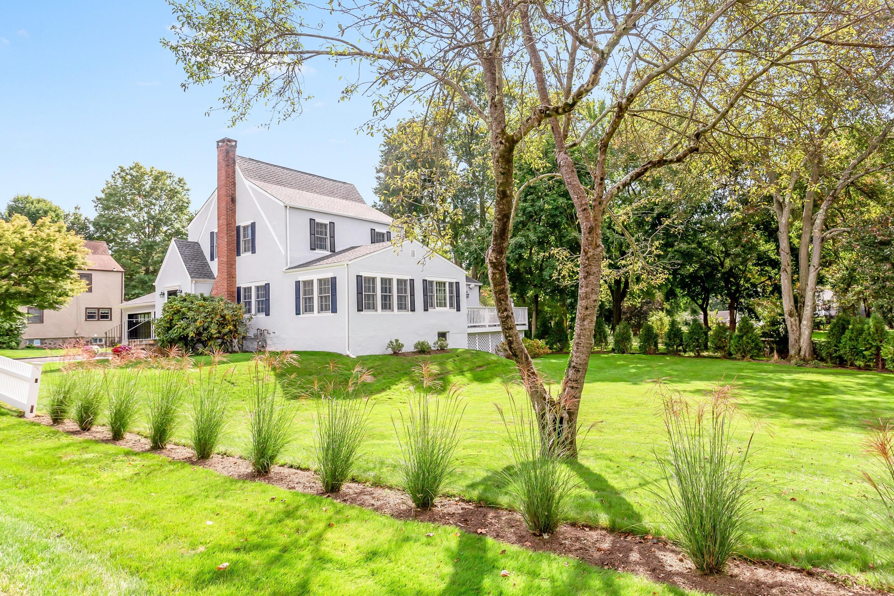 23 Renshaw Road Darien, CT 06820 - Photo 30 of 34 a view of a house with a big yard and large trees