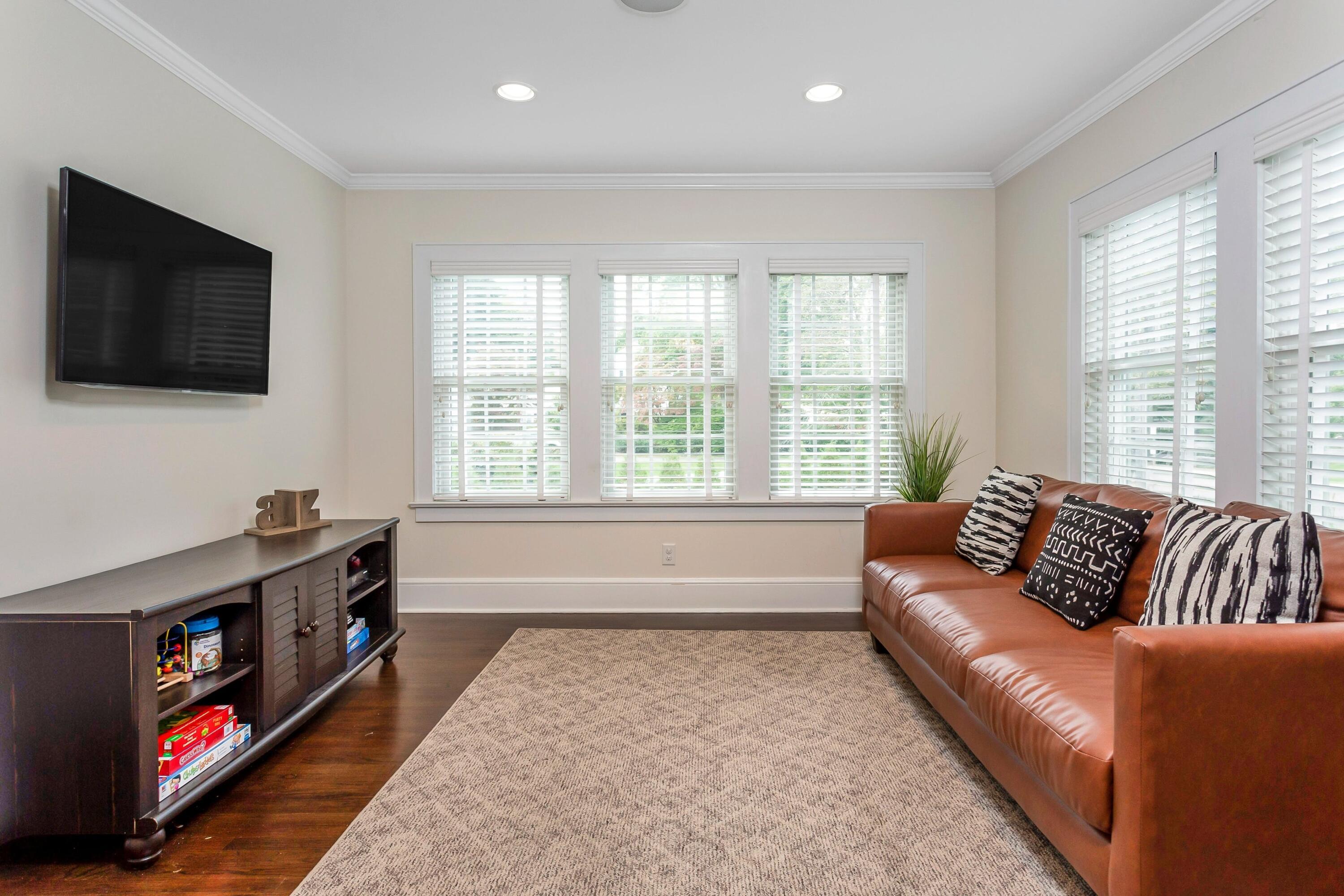 23 Renshaw Road Darien, CT 06820 - Photo 10 of 34 a living room with furniture and a flat screen tv