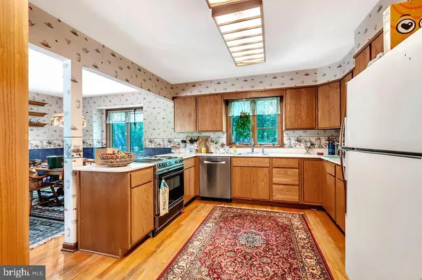 a kitchen with a stove a sink and a refrigerator