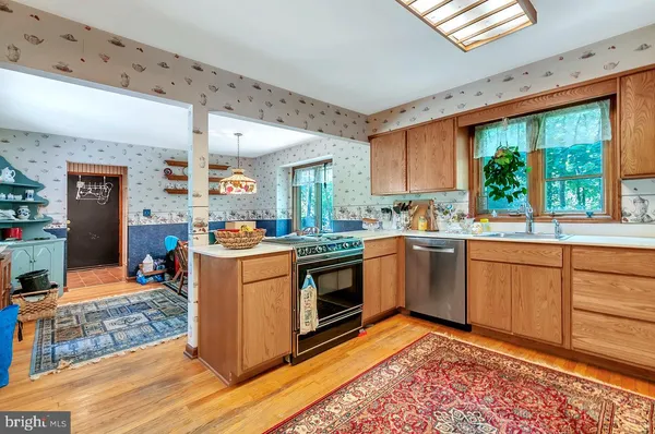 a kitchen with stainless steel appliances granite countertop a sink and cabinets