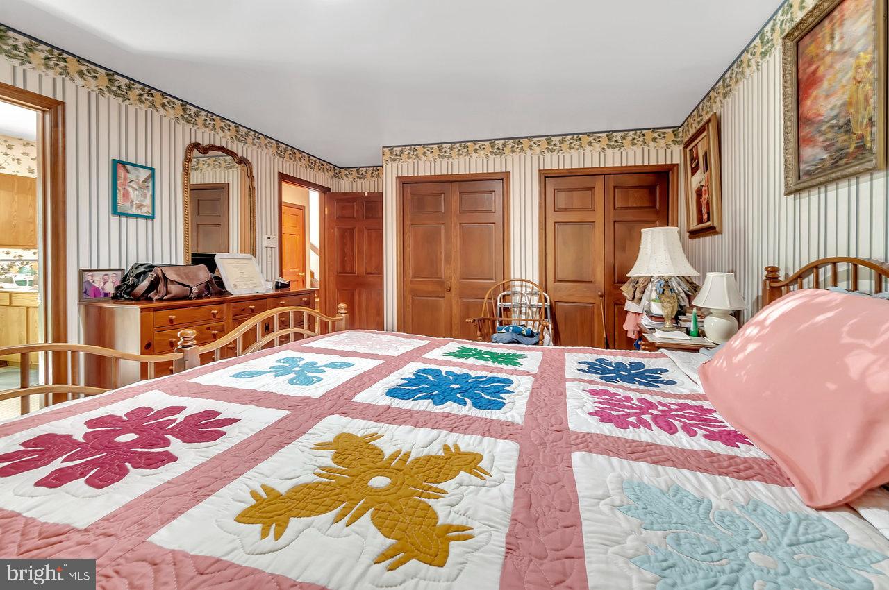 145 White Pine Road Chesterfield, NJ 08515 - Photo 22 of 48 a bedroom with a bed and wooden floor