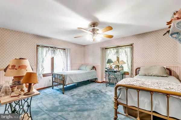 a bedroom with a bed couch and window