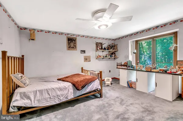 a room with a walk in closet and wooden floor