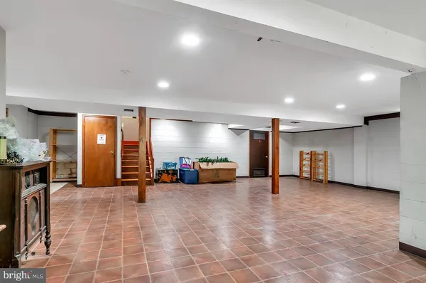 a view of an empty room and kitchen with furniture