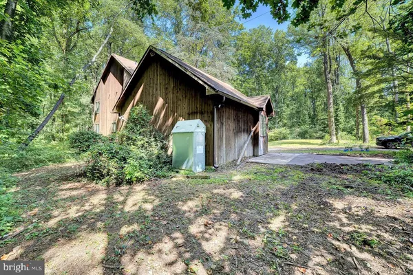 a view of a house with yard and sitting area