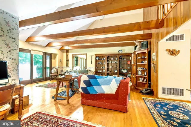 a living room with furniture a rug and a chandelier