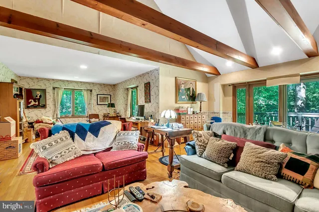 a living room with fireplace furniture and a chandelier