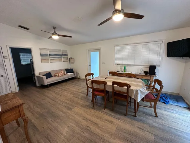 a bedroom with furniture and a wooden floor