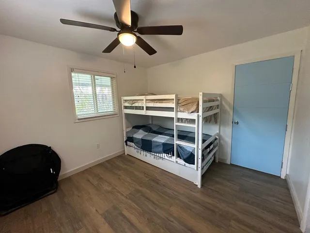 a view of a livingroom with furniture and chandelier fan