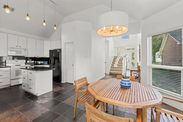 a kitchen with a dining table and chairs