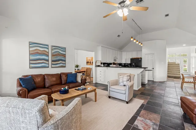 a living room with furniture and kitchen view