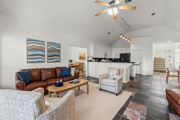 a living room with furniture and kitchen view