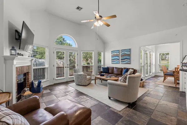 a living room with furniture a fireplace and a flat screen tv