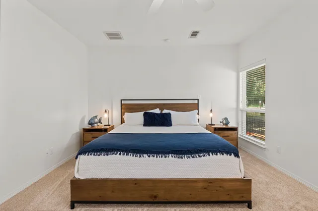 a bedroom with a bed and window