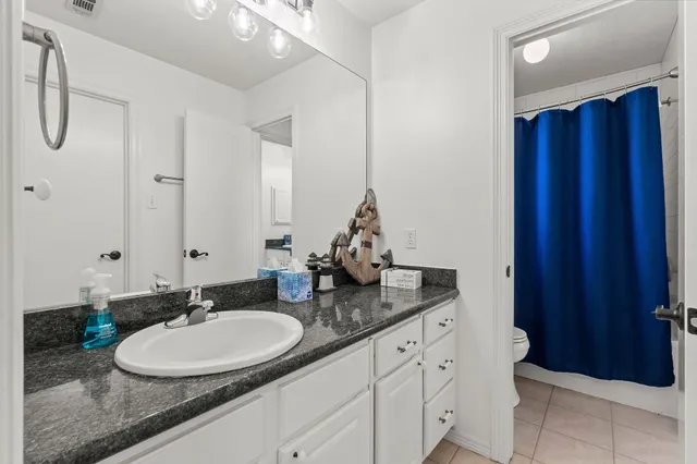 a bathroom with a double vanity sink and a mirror