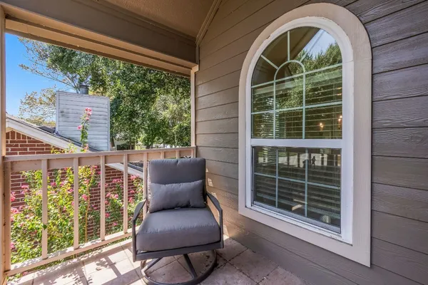 a view of a chair and table in the balcony