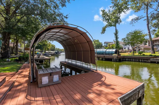a view of a wooden deck with lake view