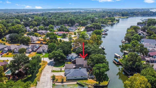 an aerial view of residential house with outdoor space and lake view
