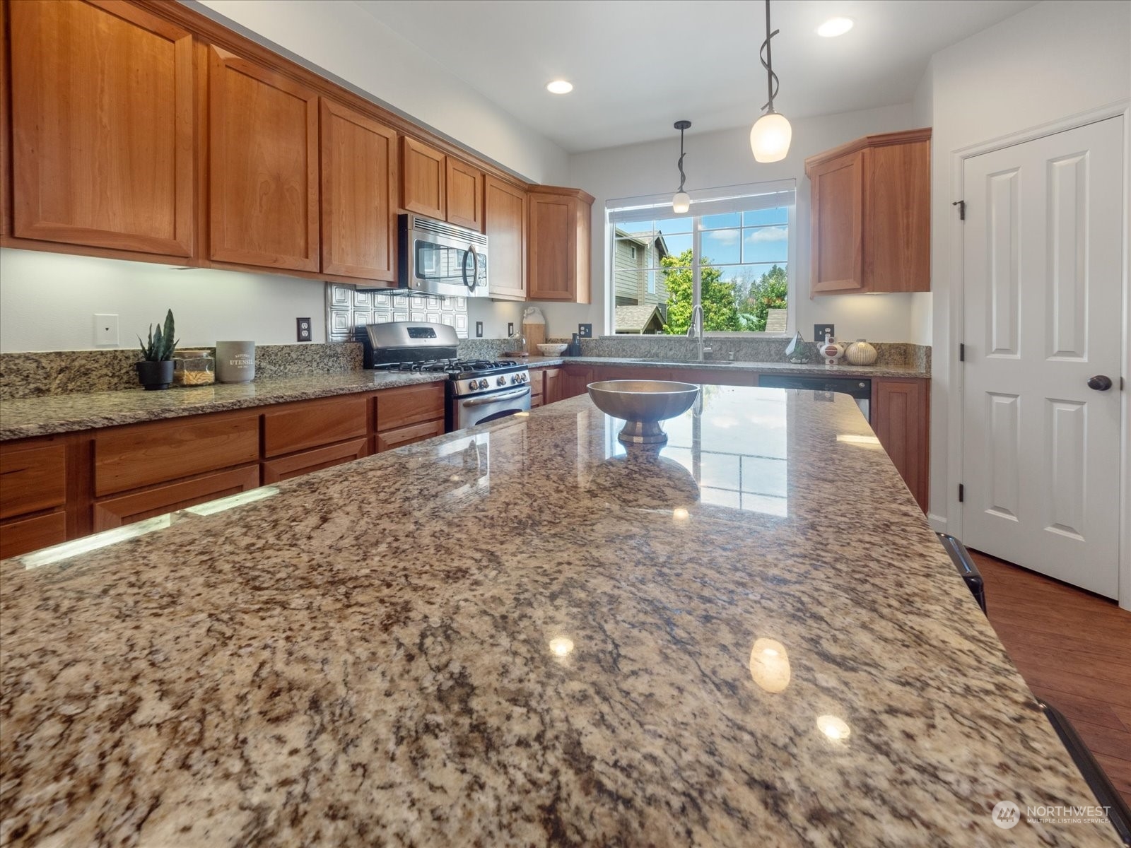 4625 Northeast 3rd Lane, Unit G3 Renton, WA 98059 - Photo 11 of 40 a kitchen with granite countertop a stove sink and cabinets