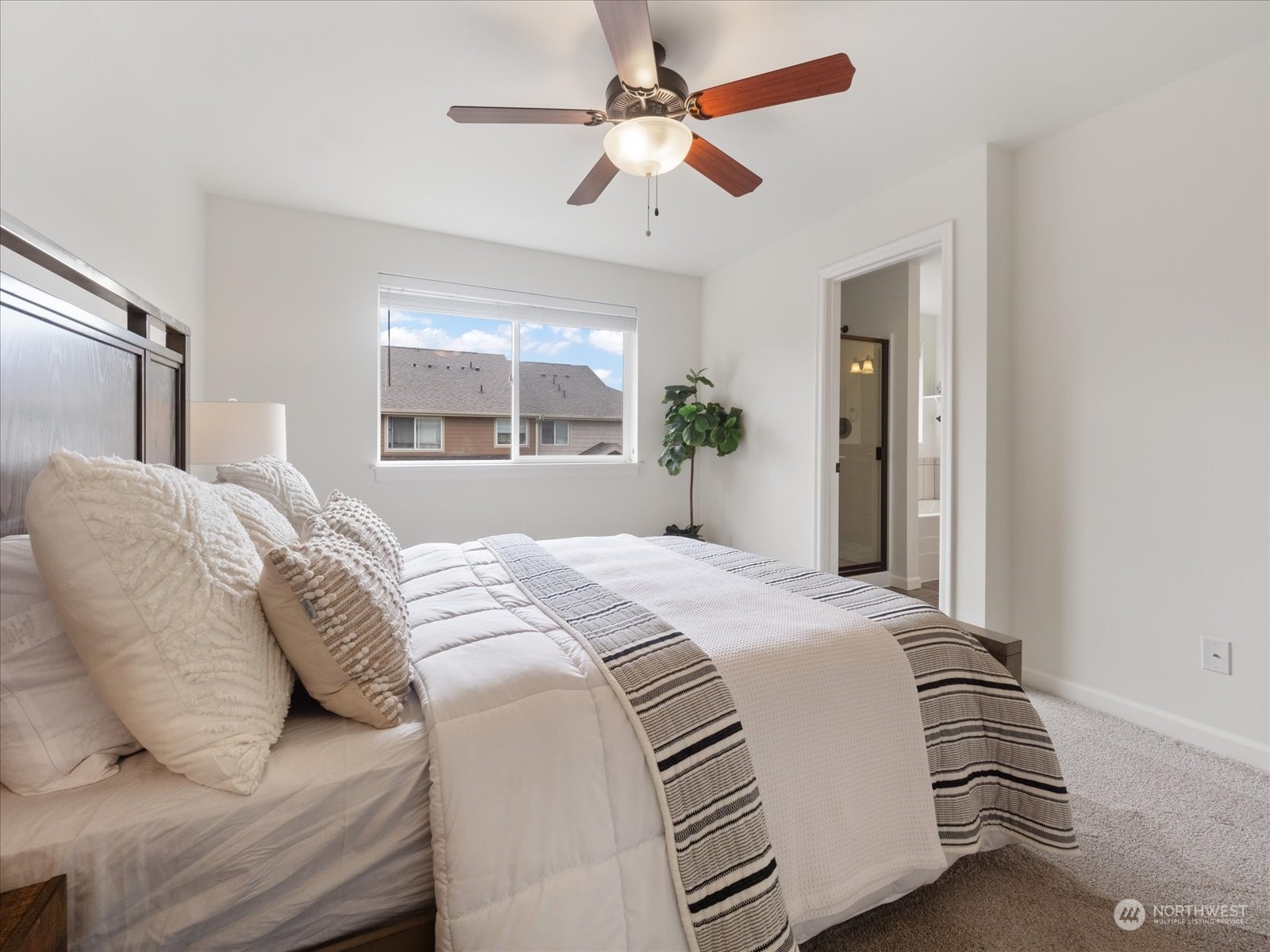 4625 Northeast 3rd Lane, Unit G3 Renton, WA 98059 - Photo 16 of 40 a bedroom with a large bed and a chandelier