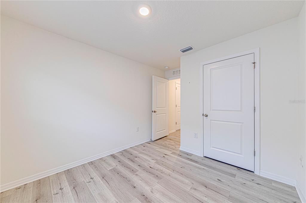 34026 Soaring Bamboo Path Wesley Chapel, FL 33543 - Photo 14 of 34 a view of an empty room with wooden floor